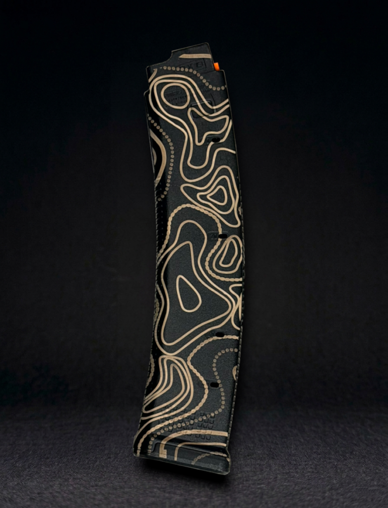 side view of a CZ Scorpion magpul pmag laser engraved with tan line topo camo pattern