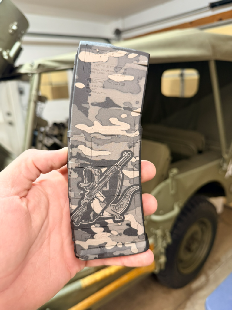 side view of a magpul pmag laser engraved with tom the lizard camo